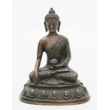 Skulptur des Buddha Shakyamuni.Bronze mit dunkel- und mittelbrauner Patina. Der Buddha sitzt auf