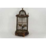 Wooden and bronze bird cage with bars, water and food bowl, after an antique example h. 70 cm.