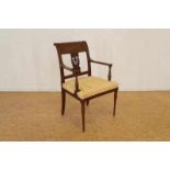 Mahogany armchair with yellow uholstery and decorated with copper piping
