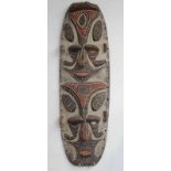 PNG, Sepik, wooden oval carved panel, ca. 1960, with in high reliëf carved faces. Painted in