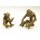 Ivory Coast, Baule, two brass sculptures. seated monkey's eating a banana. One with curved tail