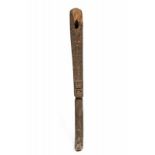 Papua, Teluk Cenderawasih, wooden axe handle,with low relief continuous pattern and a Kowar figure