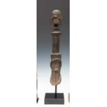 Nigeria, Wurkun, pole shaped anthropomorphic figurewith a black encrusted patina and a brass ring