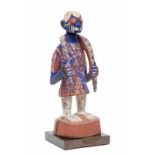 Nigeria, Yoruba, standing male figuredressed in a tunica holding a snake, draped around the