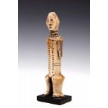 DRC., Lega, ivory standing figurewith rhombic shaped face and decorated with engraved lines and