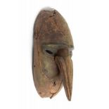 PNG, Lower Sepik, mask,with long pointed nose and traces of black and green pigments. L. 35 cm. [1]