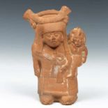 Mexico, Maya, flute figure of a standing mother with child, 300-900,with remnants of pigments.