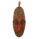 PNG, Lower Sepik, mask,the facial details in red and blackened eyes, pierced nose, the head dress