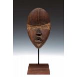 Ivory Coast, Dan, face mask, deangle,mask with forehead ridge, narrow slit eyes in between curved