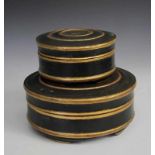 Java, two cylindrical lidded boxes,in black with gold raised concentric bands. diam. 29,5 and 21 cm.