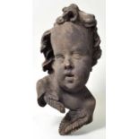 Kopf eines Putto, BarockstilHolz, geschnitzt, geschwärzt, H. 34,5 cm