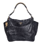 Prada, a black soft grain leather tote bag, with a black leather and yellow metal hardware handle,