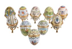 Ten Halcyon Days enamel Easter eggs, 1980 to 1989, each in its box; with some stands