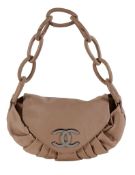 Chanel, a tan soft leather handbag, with a tan leather shoulder strap composed of oval links, the