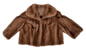 A lady's pastel mink bolero jacket, with 3/4 length sleeves, invisible closer and brown lining, no