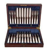 Ω A cased set of twelve Edwardian fruit knives and forks with silver ferrules by Harrison