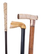 Ω Three ivory handled walking sticks, comprising: a 19th century Chinese cane, the tapering