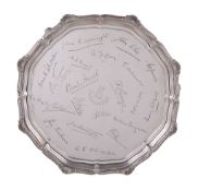 A silver shaped circular salver by Elkington & Co., Birmingham 1931, with a shell and moulded