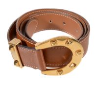 Hermes, a tan leather belt, 1978, blind stamped H in a circle, with a gilt horseshoe buckle