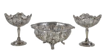 A pair of silver pedestal sweet baskets by Henry Matthews, Birmingham 1912, with scroll rims,