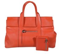 Salvatore Ferragamo, an orange leather handbag, with twin loop handles, a single external zip