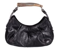 Yves Saint Laurent, Mombasa, a black leather handbag, with a horn handle, press button fastener