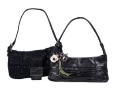 Fendi, a black clutch bag, with a black leather loop handle, the flap opening to a green satin