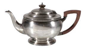 A silver compressed spherical tea pot by G. Bryan & Co., Birmingham 1946, with a composition button