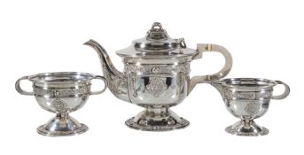 Ω An Irish silver circular pedestal three piece tea service by Alwright & Marshall Ltd, Dublin