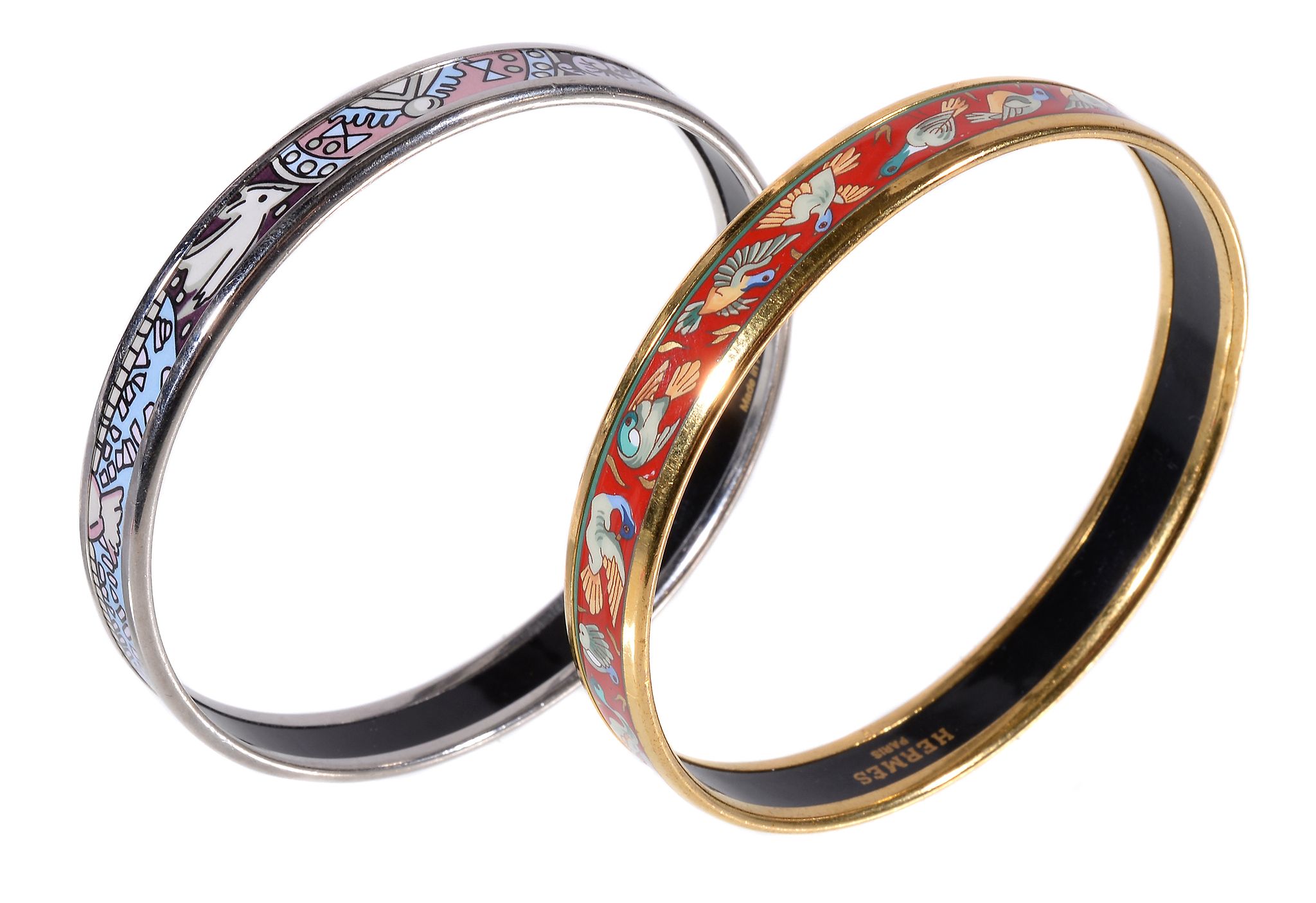 Hermes, two gilt metal and enamel bangles, ducks on a red ground and stylised artwork, each 6.5cm