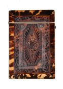 Ω A Victorian pressed tortoiseshell rectangular card case, with musical trophies within shaped