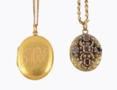 A Victorian garnet locket , circa 1850, the oval panel with applied scrolled cannetille decoration