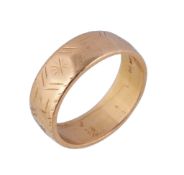 A 22 carat gold band ring, the band with rubbed decoration, London hallmark, finger size X 1/2