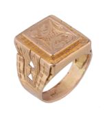 A gold coloured panel ring, with foliate decoration, stamped 23c, finger size S