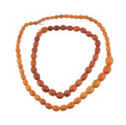 An amber bead necklace, composed of graduating amber beads, 43cm long; and a further amber bead