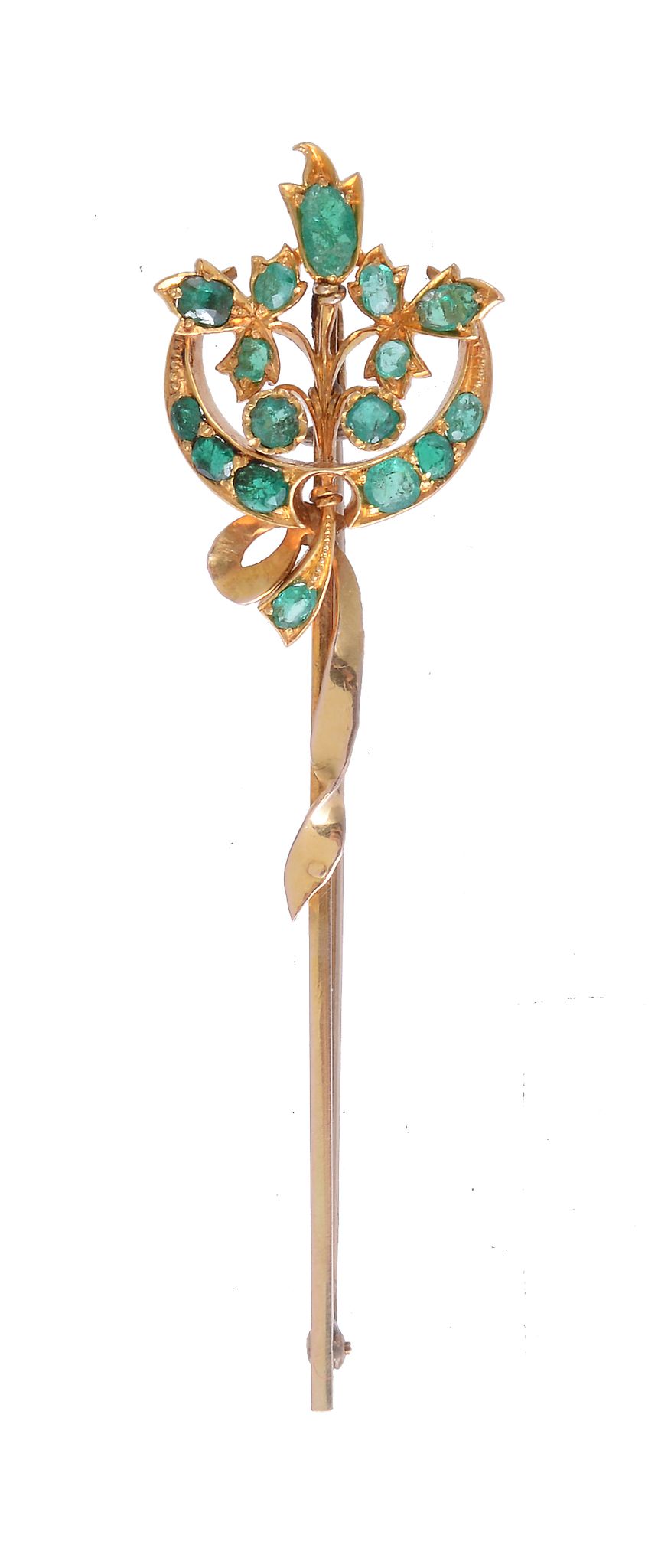 An emerald and gold brooch, the Victorian floral spray and crescent set with vari cut emeralds, on