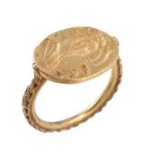 A gold intaglio ring, the oval panel carved with a lady holding a chalice, to an applied wire