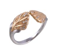 A diamond dress ring, the ring with leaf shaped terminals with brilliant cut diamond accents,