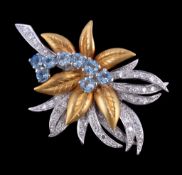An 18 carat gold aquamarine and diamond brooch, designed as a foliate spray, set with circular cut
