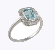 An aquamarine and diamond cluster ring, the step cut aquamarine with canted corners within a