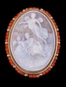 A shell cameo brooch/pendant, the oval shell cameo carved with a seated lady with Psyche and two