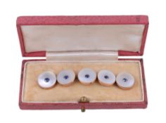Ω A set of five Edwardian mother of pearl and sapphire buttons, the circular mother of pearl panels