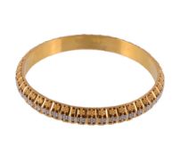 A gold coloured bangle, the hollow bangle with beaded flower head decoration with facetted bars