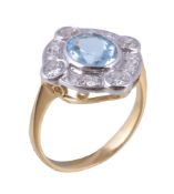 An aquamarine and diamond cluster ring , the central oval cut aquamarine within a surround of