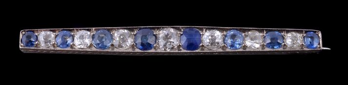 A 1930s sapphire and diamond bar brooch, set with alternating circular cut sapphires and old