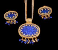 A 9 carat gold lapis lazuli pendant and pair of earrings, the oval lapis lazuli panel within a