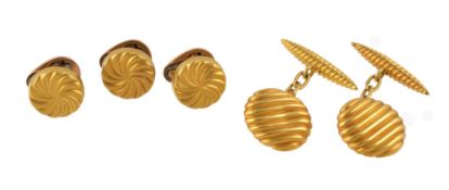 A pair of late 19th century French gold cufflinks, circa 1890, the swirled panels with belcher link