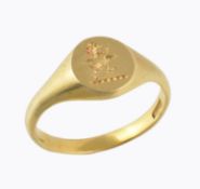 A gold coloured signet ring, the oval panel with a chased rampant lion, the shank stamped 18ct, 5.