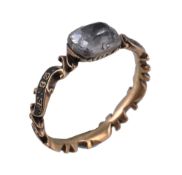 An 18th century rock crystal mourning ring , the foil backed cushion cut rock crystal to a scrolled