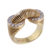 An 18 carat gold and diamond ring by David Thomas, the bungee style panel set with brilliant cut